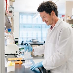 Scientist using a pipette in a lab