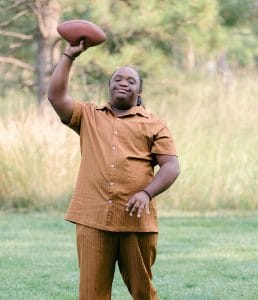 Man with Down syndrome holding a football